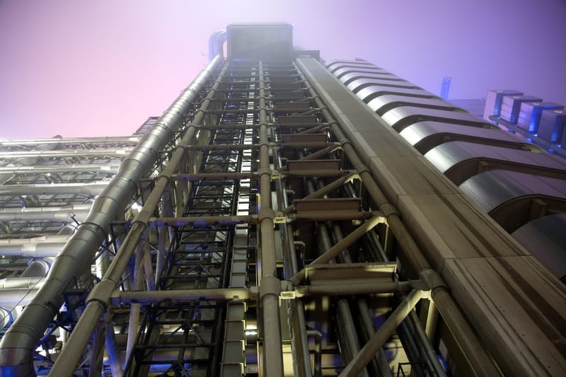 Looking straight up the steel lift towers of the Lloyd's building into mist