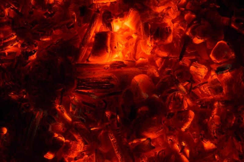 Close-up of glowing embers, red and gold
