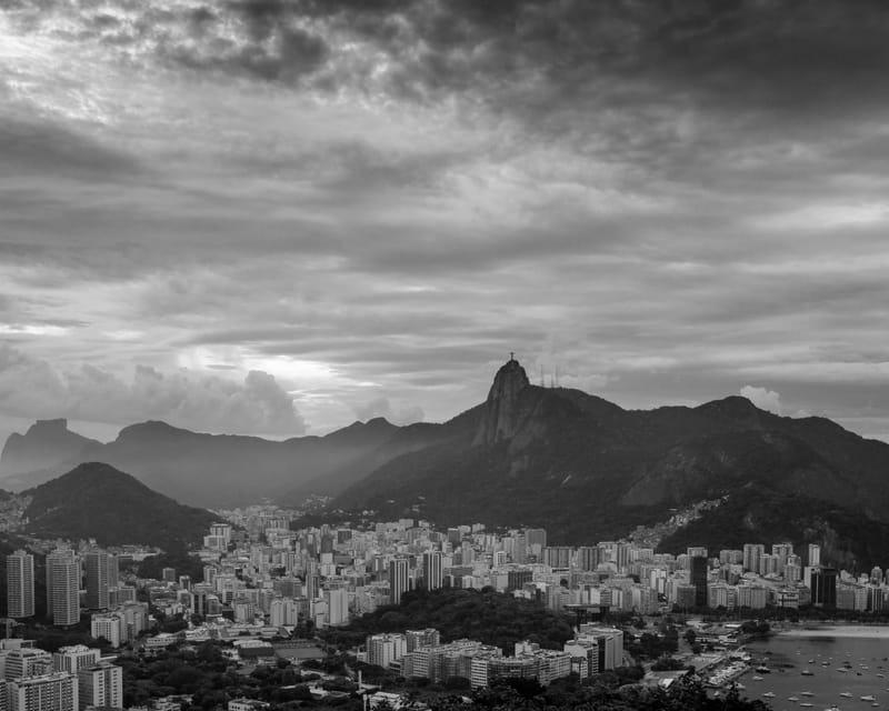 Black and white view over Rio de Janeiro under heavy cloud, Christ the Redeemer on the peak