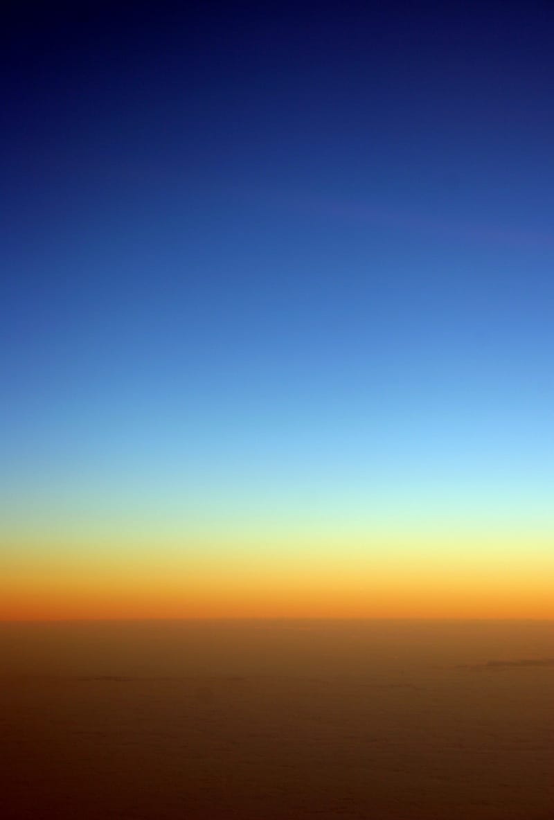 Deep blue dusk fading to amber over the Atlantic
