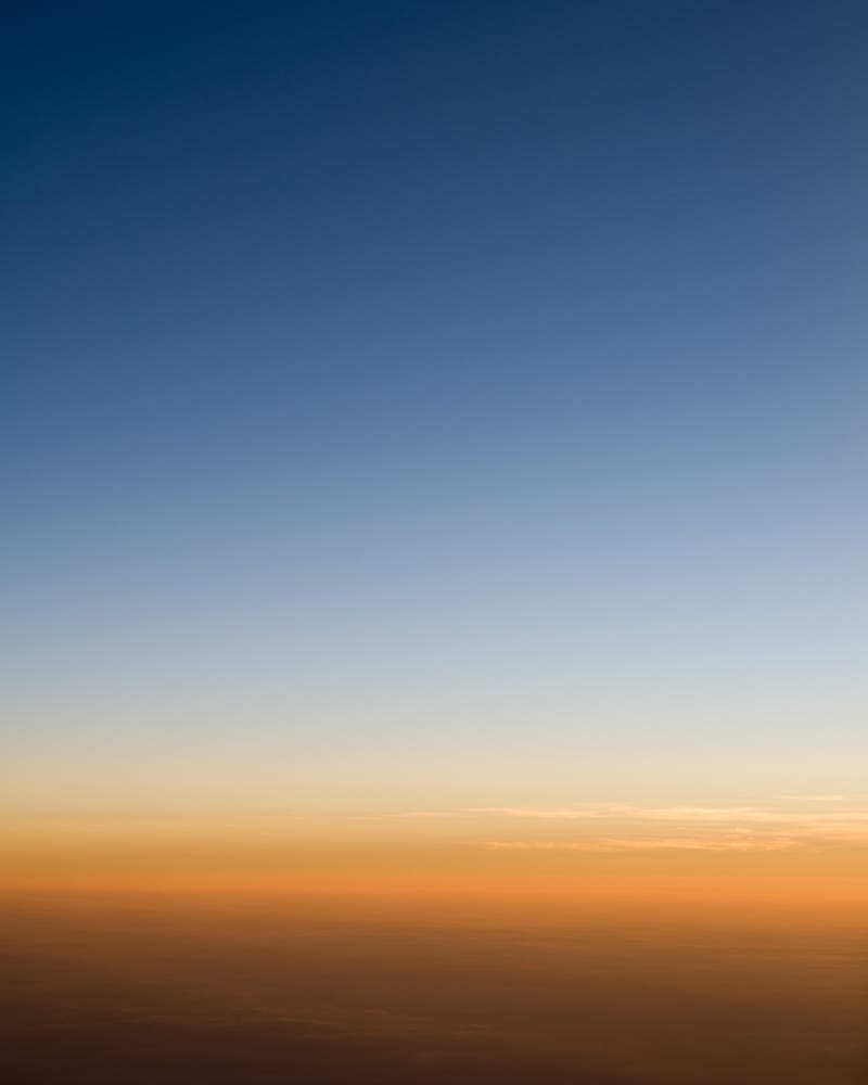 A soft dawn gradient over a hazy horizon